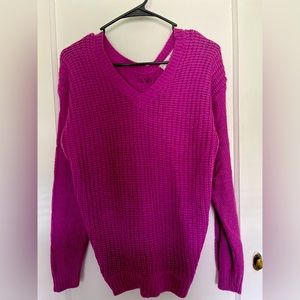 Knitted fuchsia sweater with Ribbon tie in back .